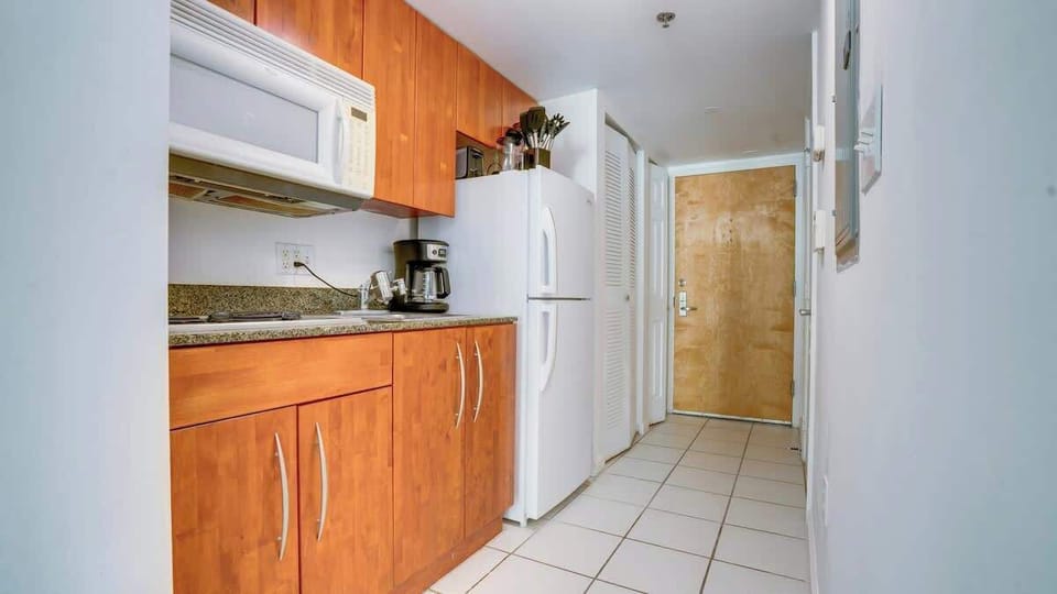 Efficiency meets elegance: A compact kitchenette, equipped with modern appliances and stylish finishes, offering convenience without compromising on sophistication in your cozy retreat.