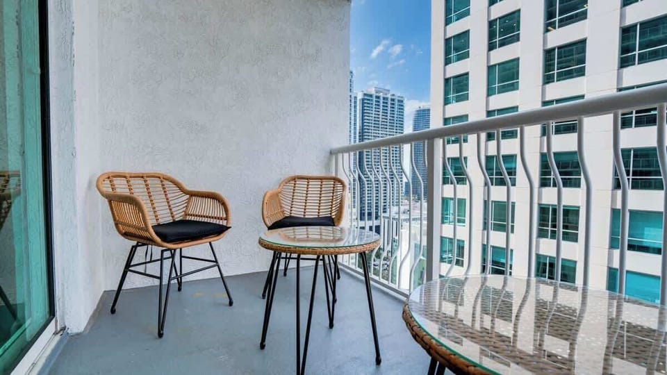 Your personal oasis in the sky: A cozy balcony seating area, perfect for enjoying morning coffee or evening cocktails while soaking in the ambiance of the surrounding and nearby water views.