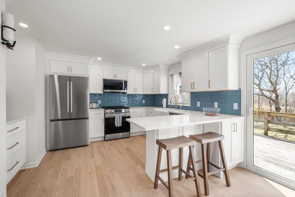 Fully stocked kitchen with new appliances, gas range, farmer`s sink, breakfast bar, and coffee nook.