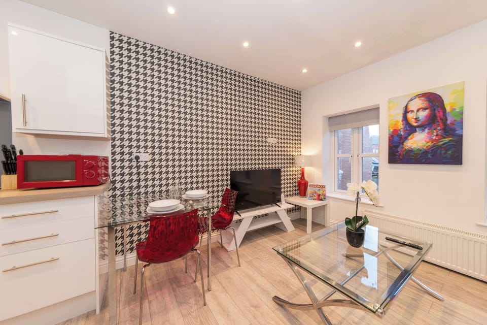 Dining and living space from the entrance. Glass table seats four comfortably. Houndstooth feature wall throughout.