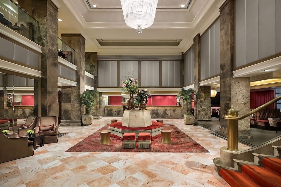 Arrive in style beneath a sparkling chandelier and marble floors.