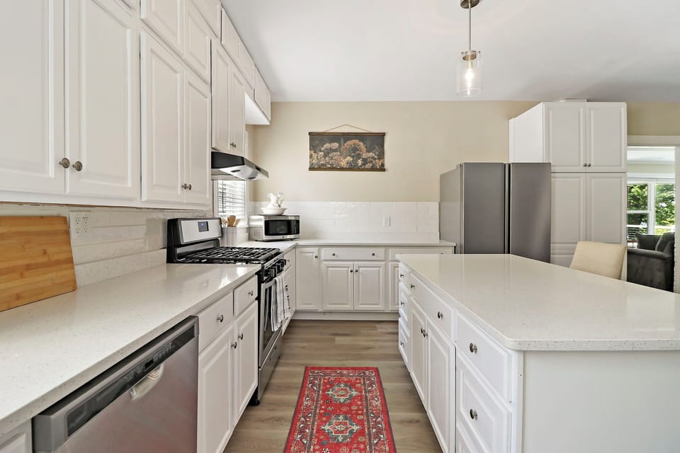Open concept kitchen includes breakfast bar in fully equipped kitchen.
