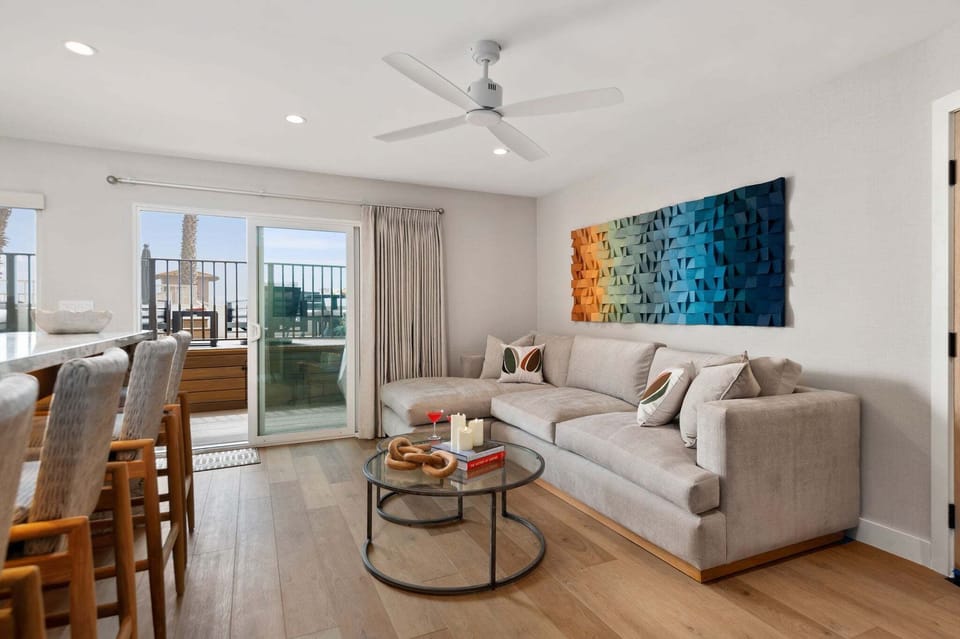 Comfortable living room, couch, extending out to the beachfront deck.