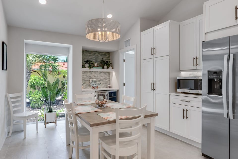 Dining area with service for eight with leaf and wet bar pictured behind