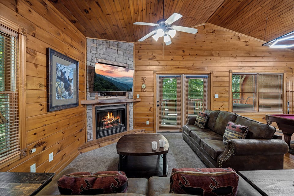 Spacious living room with TV, sleeper sofa, and fireplace