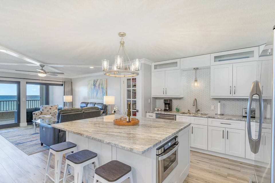 Kitchen with large island overlooking den and gulfview
