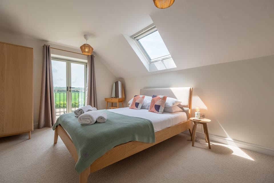 First floor: Master bedroom with king-size 5ft 6" bed and Juliet balcony