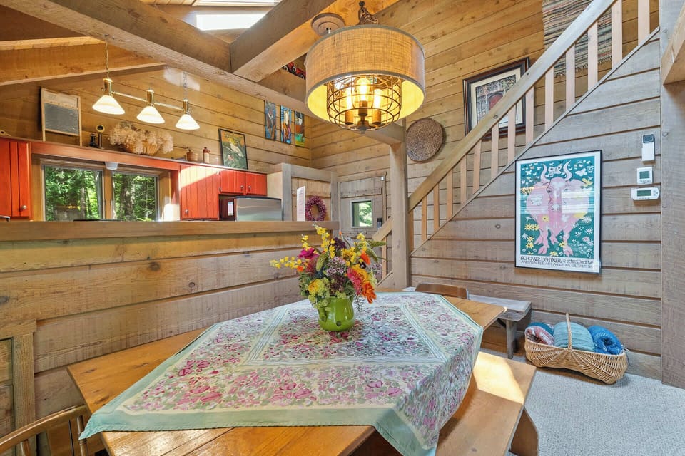 View of the dining table looking towards the main entrance and stairway to the second floor