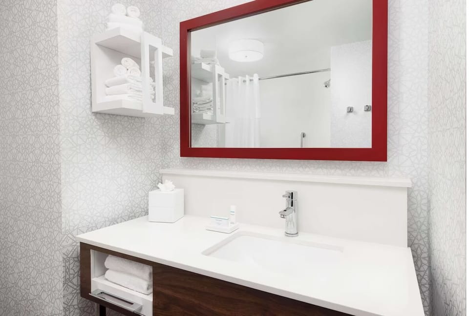 Refresh in a bright, spotless bath with fluffy towels ready.