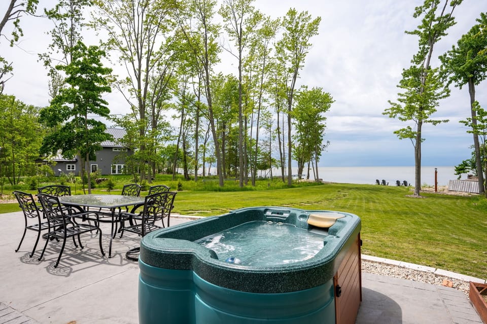 Relax and unwind in your backyard oasis! Enjoy the hot tub with stunning lake views!