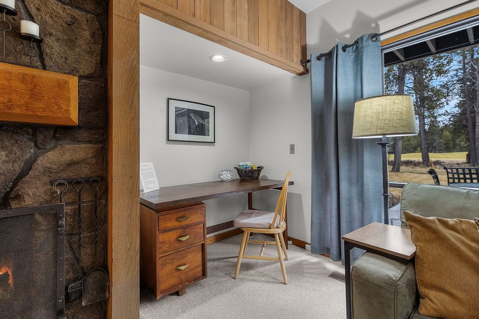 Settle into your private workspace with mountain views, where warm wood tones and natural light create the perfect spot for productivity.