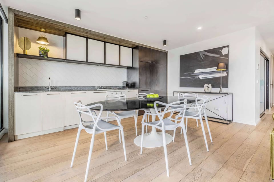 DINING ROOM: An elegant dining area filled with natural light and anchored by a beautifully crafted David Hicks table, setting the perfect stage for unforgettable meals and entertaining evenings.