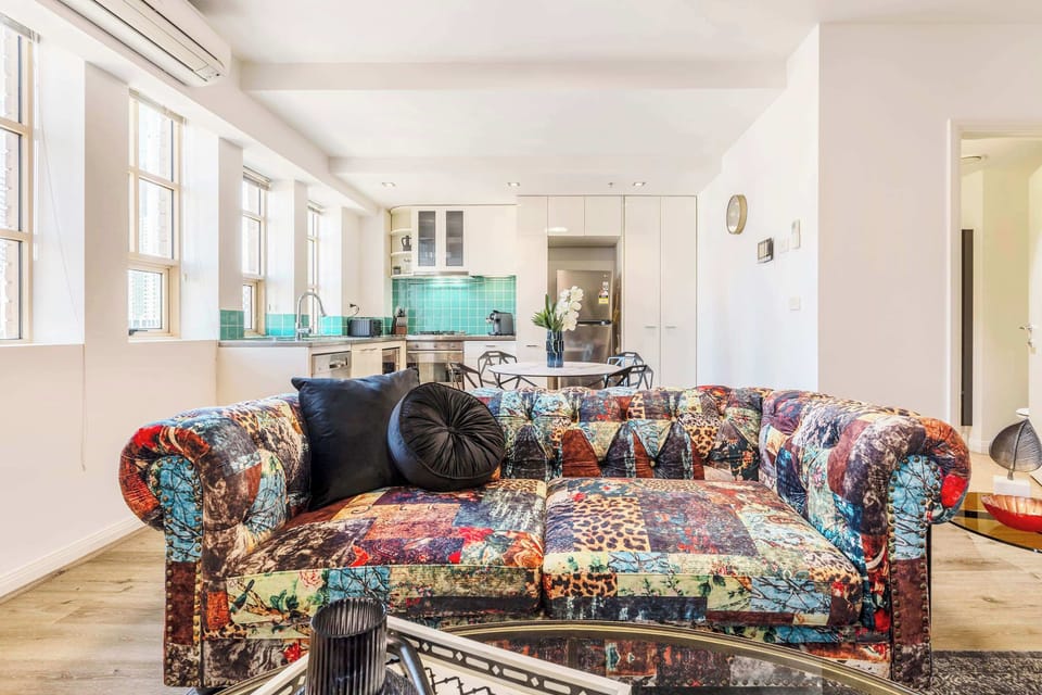 LIVING ROOM: A statement sofa, a mirror fit for a soirée, and views worth raising a glass to. This is the heart of Gatsby.