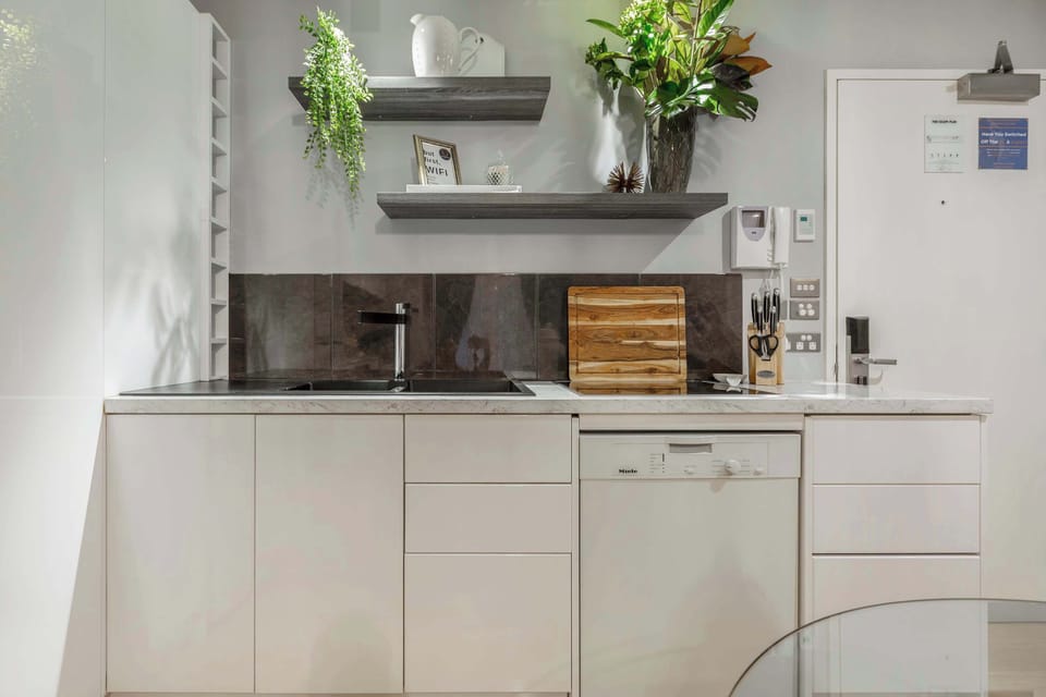 Compact modern kitchen with sleek cabinetry, dishwasher, and the essentials for a comfortable stay