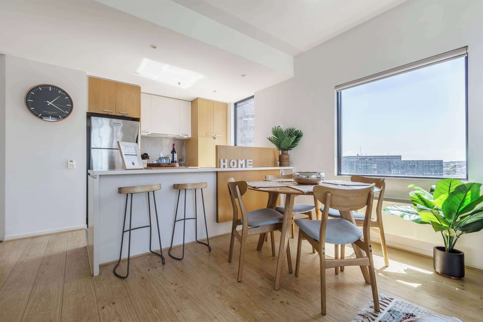 Open plan layout with a dining table and breakfast bar
