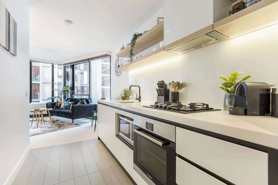 Cook with ease in the fully equipped modern kitchen, complete with sleek finishes and open shelving