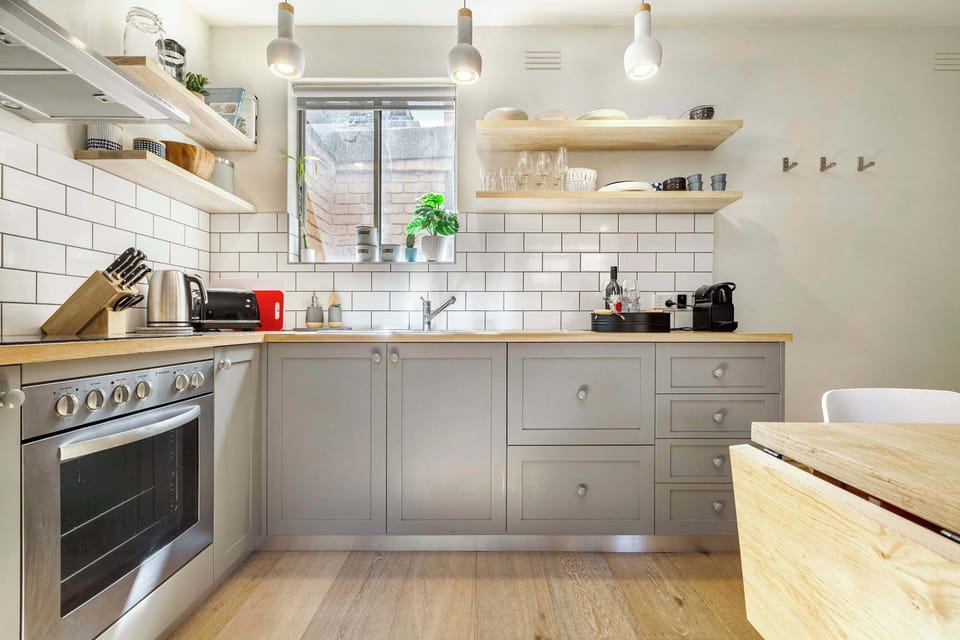 Kitchen at Sonder: Stylish kitchen with subway tiles, wooden benchtops, and all essentials