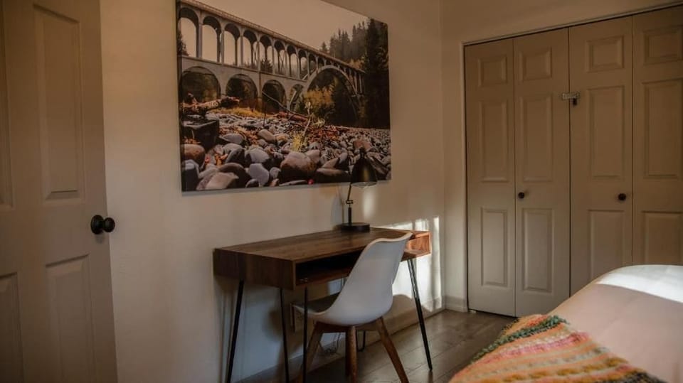 The main bedroom features a secluded and dedicated work space