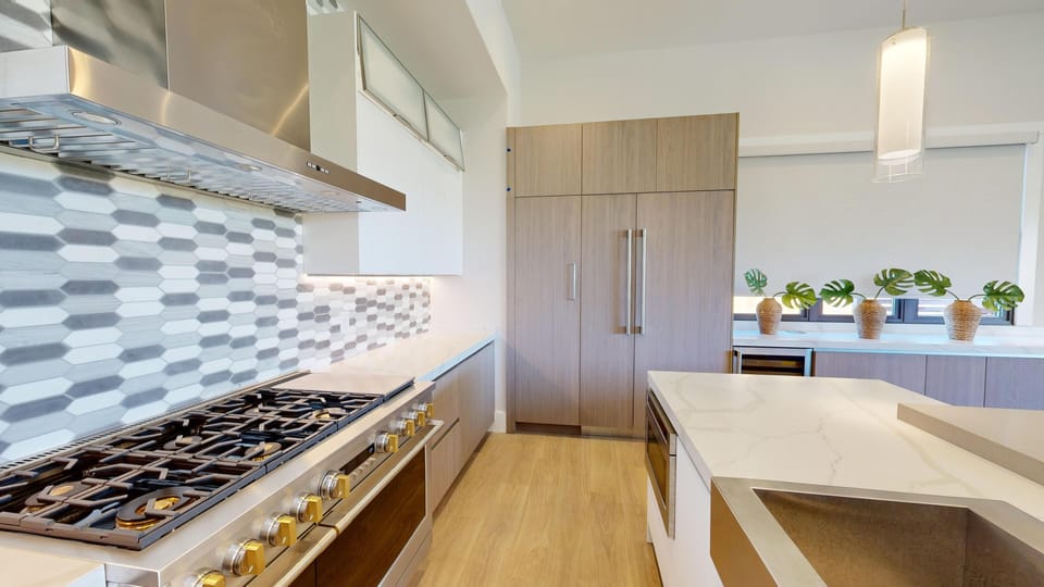 Gourmet kitchen with 6 burner gas stove, built in refrigerator and win chiller