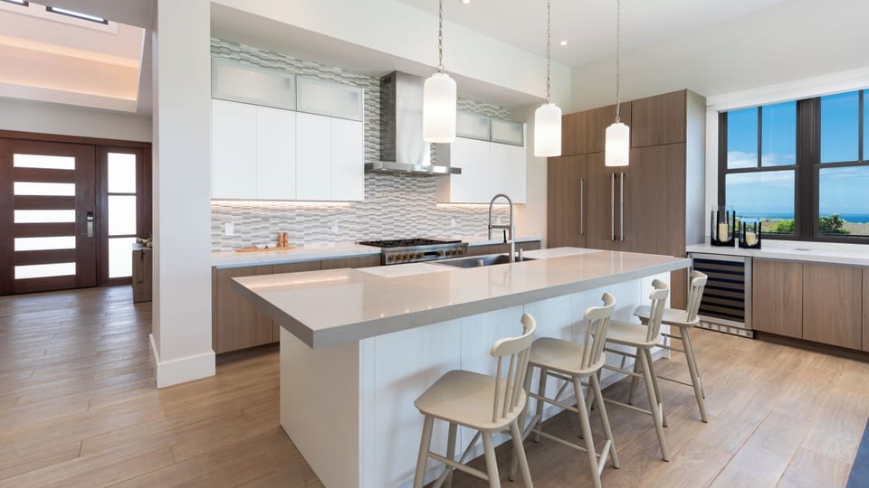 Gourmet Kitchen with high end appliances and wine chiller. Additional island seating