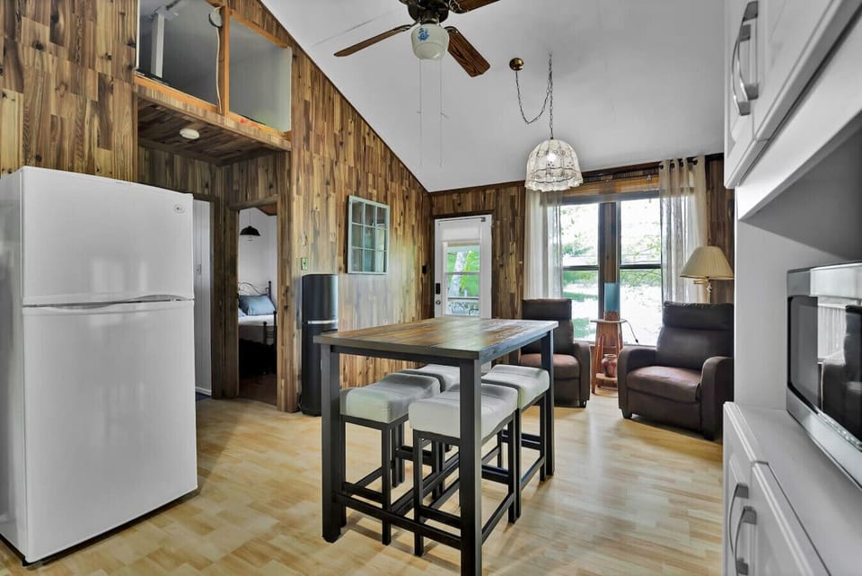Bright dining nook with seating for four, opening onto the lakeside deck.