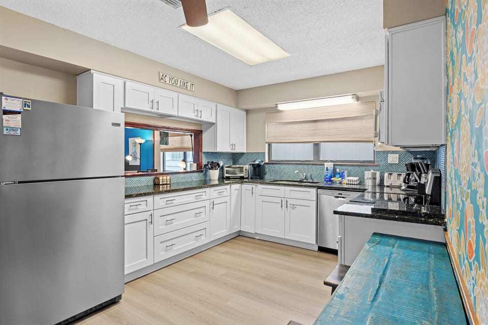 Kitchen features ample counter space and modern stainless steel appliances.
