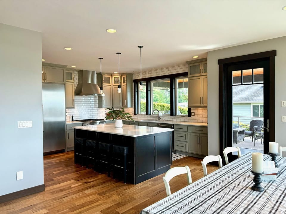Well appointed kitchen with dining table and bar. Door to patio.