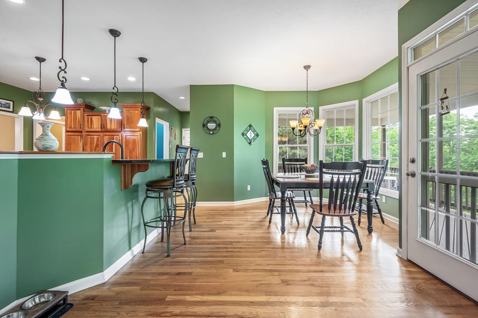 Open kitchen and breakfast area with bright windows and seamless access to the outdoor patio.