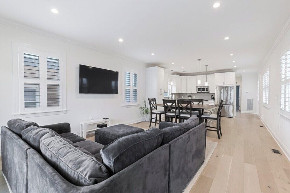 Entertain and relax in this beautifully lit, modern open-concept space, perfect for hosting family and friends. The fully equipped kitchen with its large central island and stainless- appliances flow seamlessly into a cozy living area.