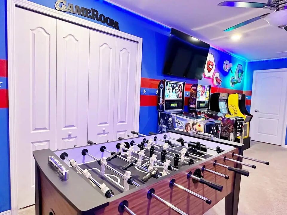 : Professional foosball table, stand-up arcade machine, and a cozy futon.