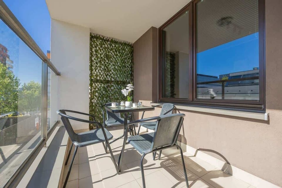 The furnished balcony with chairs and a table is a perfect spot for morning coffee or evening relaxation in the open air.