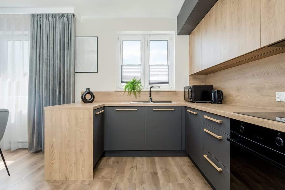 A functional kitchen with a large countertop and bright window makes it easy to prepare any meal.