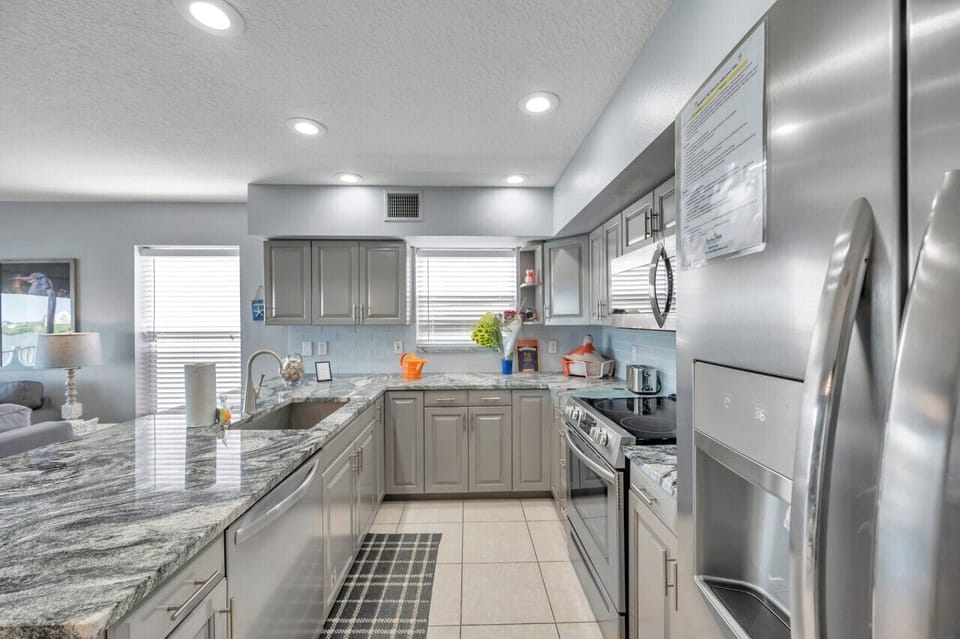 Spacious kitchen w/ stainless appliances, ample cabinets & generous prep space.