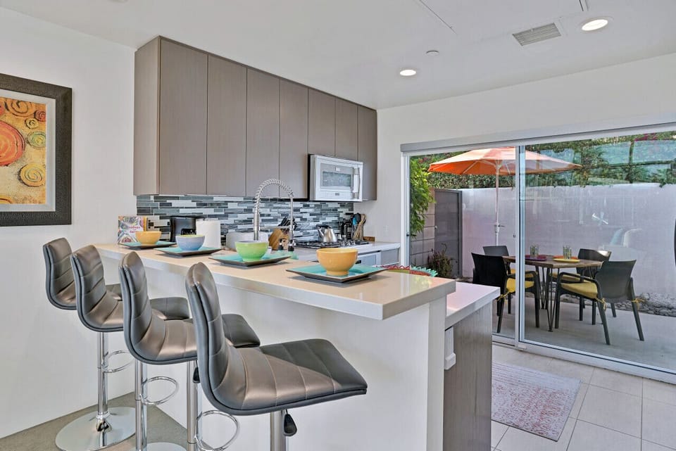 Modern kitchen with breakfast bar and patio access