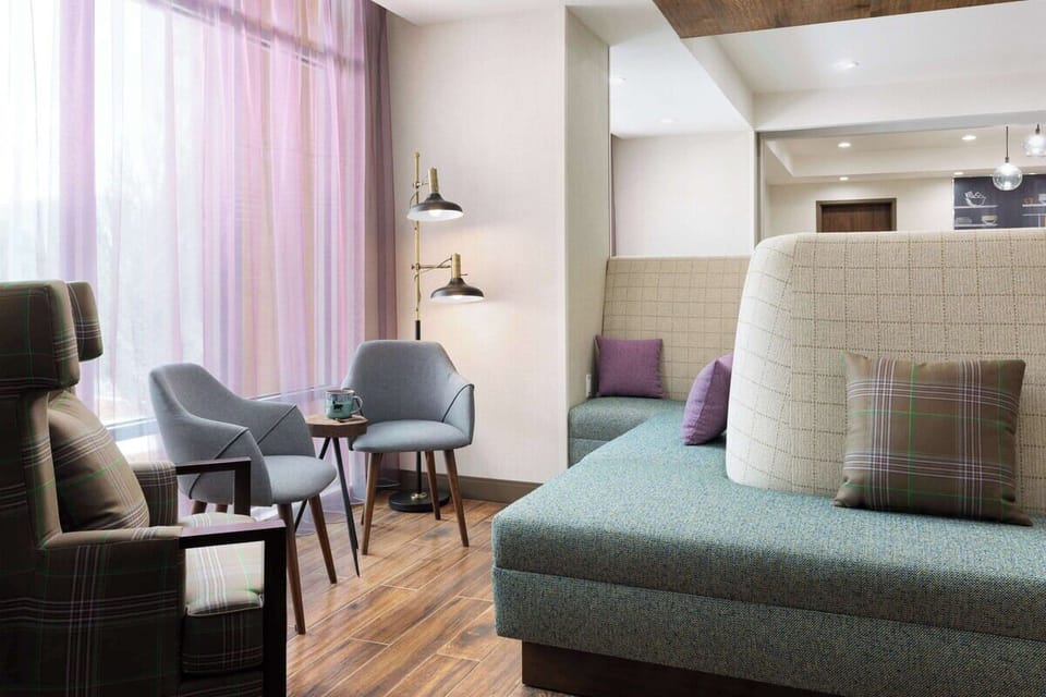 Relax with a book in soft chairs by filtered daylight.