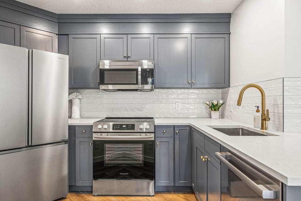 Beautifully renovated kitchen, with quartz counter tops, stainless steel appliances and brass fixtures.