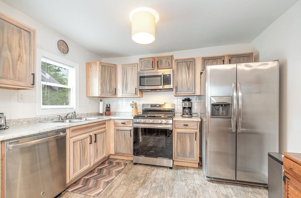 Fully stocked kitchen with pots, pans, dishes, coffee maker and Keurig