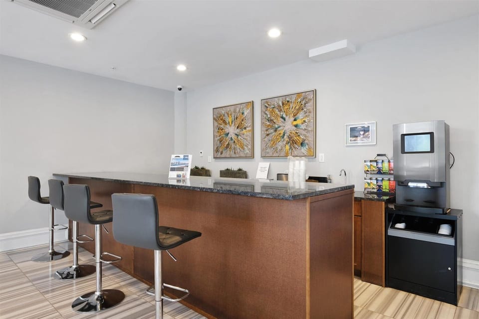 Elegant building lobby with 24/7 concierge service and complimentary coffee and tea station.