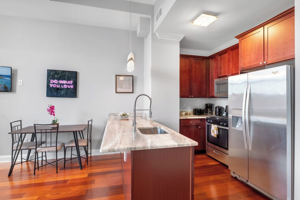 Kitchen featuring breakfast bar, pendant lighting, and ample counter space for meal preparation.