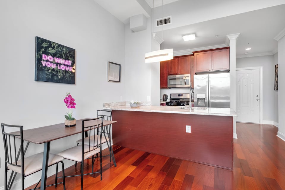 Dining area with contemporary furniture and breakfast bar ideal for enjoying meals or working from home.