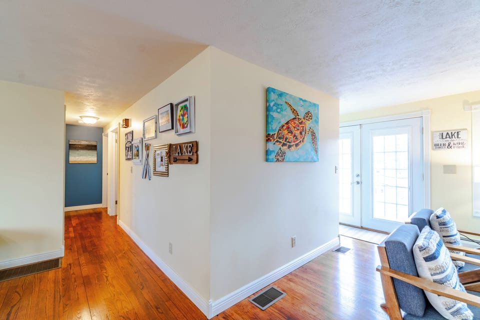 Hallway to bedrooms and first bathroom to the left; and French doors to the deck