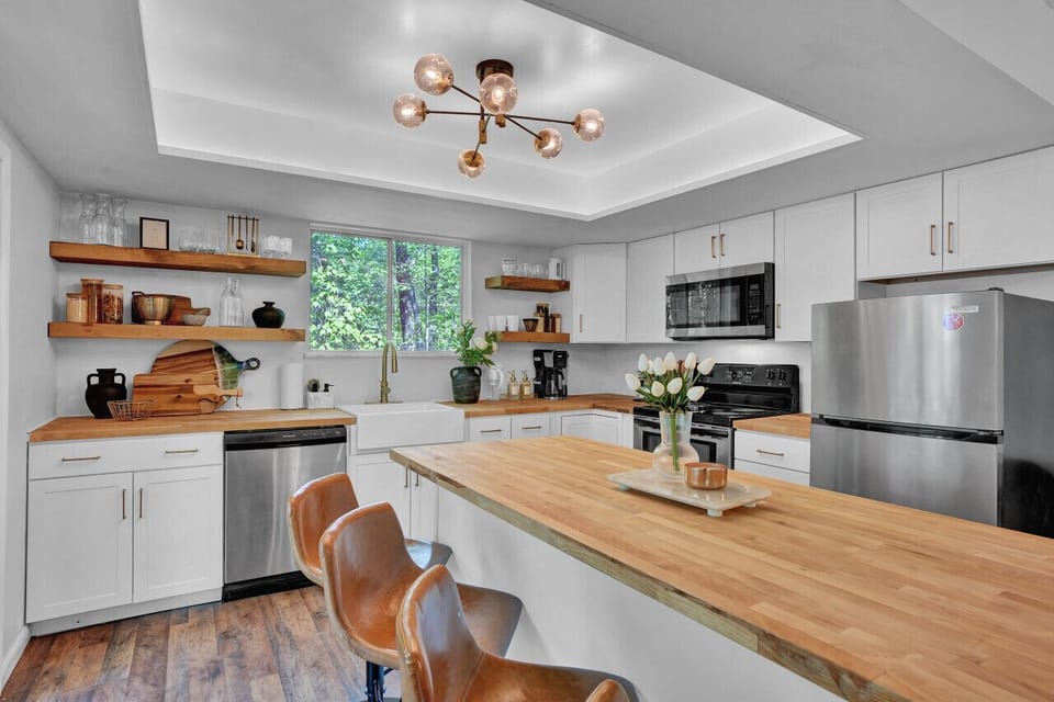 Watch a sunset lake view from the fully stocked open shelving kitchen.