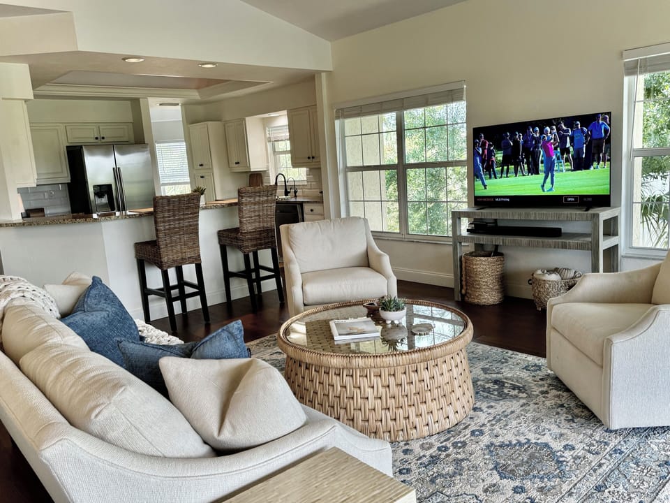 Cozy living room open to kitchen and lanai; views of preserve and lake.