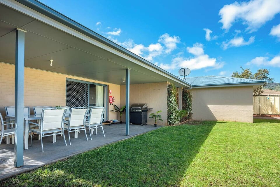 The grassy backyard is secured for the family pet and comes with a new fire pit.