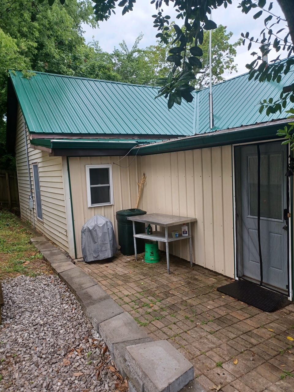 Back door patio with barbecue next to the door that goes into the kitchen