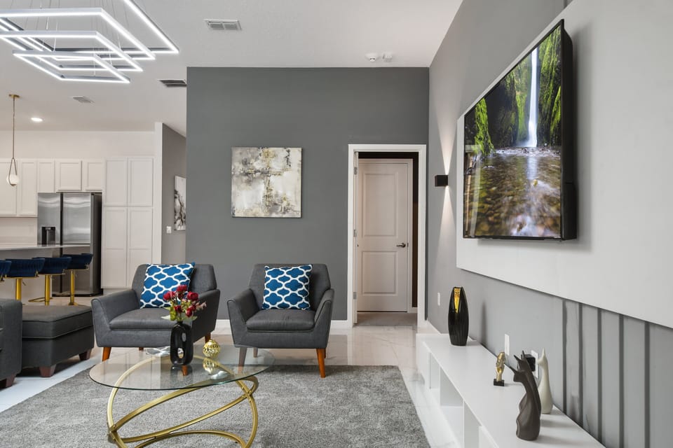 Chic lounge with modern accents, smart TV, and cozy seating for relaxing nights
