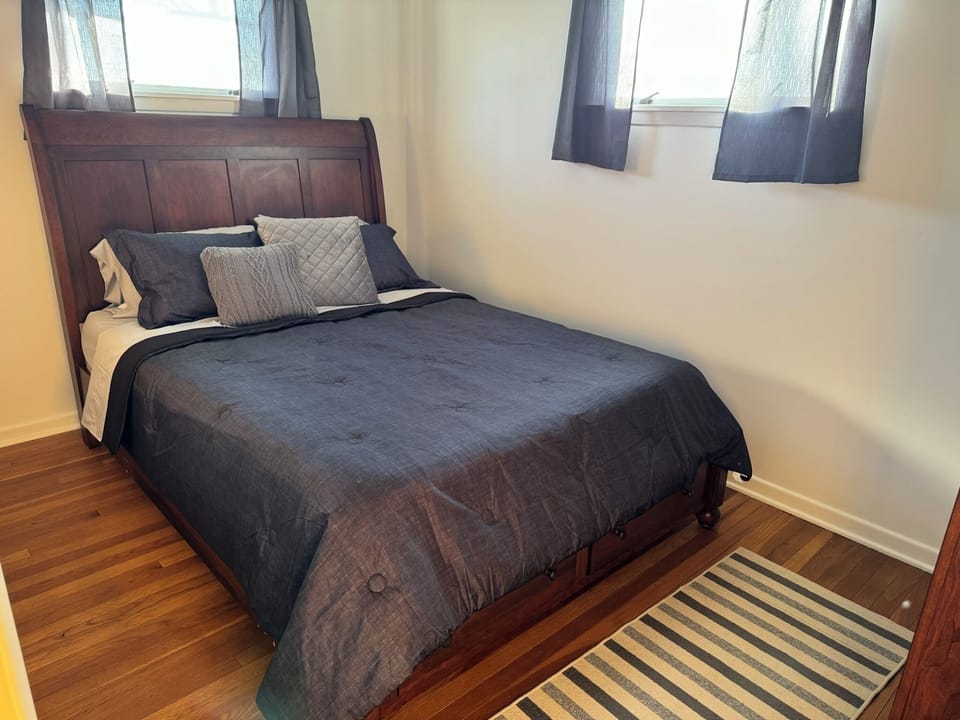 Bedroom containing queen bed and closet