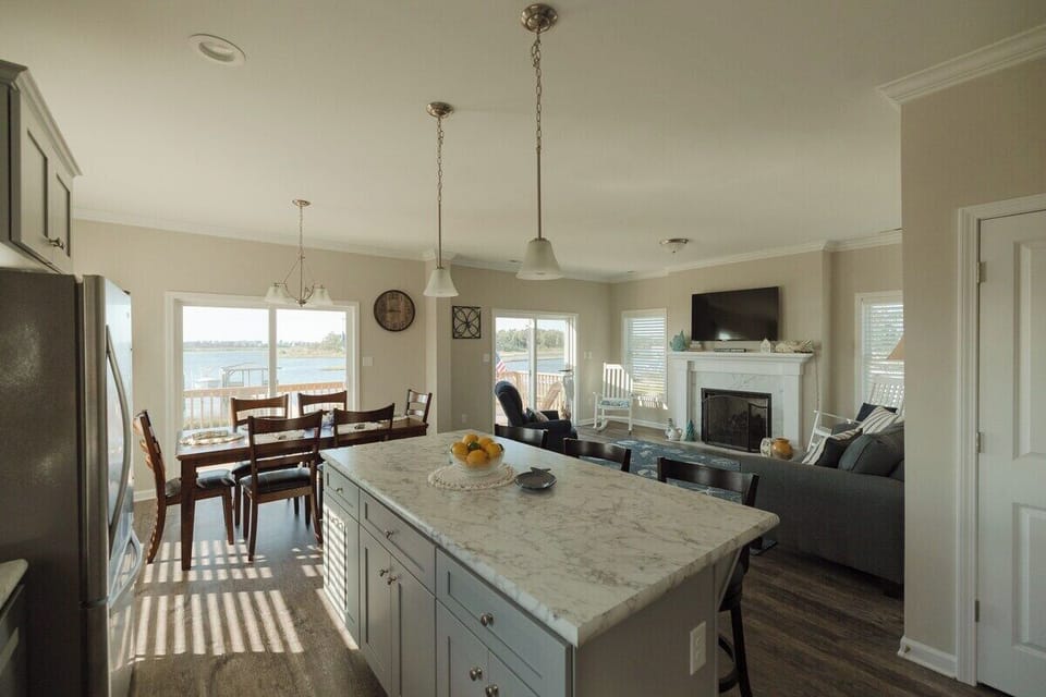 Large kitchen island with additional seating provides the perfect space for casual meals, coffee, or gathering while cooking.