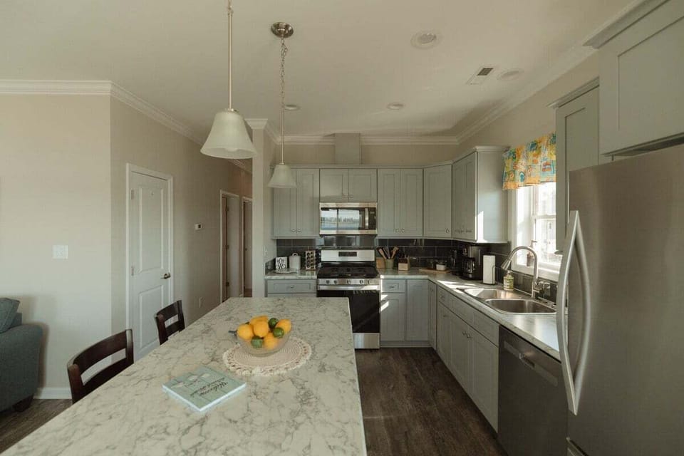 Large kitchen island with additional seating provides the perfect space for casual meals, coffee, or gathering while cooking.