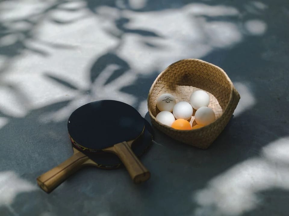 Challenge friends to a sunny ping‑pong match between swims.